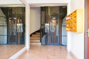 a hallway with glass doors and stairs in a building at Place to beach - Bord de mer Croisette in Cannes
