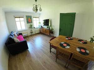 a living room with a wooden table and a dining room at Stacja Srebrna Góra in Srebrna Góra