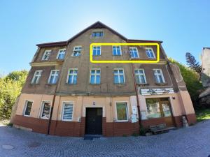 an old building with a yellow frame on top of it at Stacja Srebrna Góra in Srebrna Góra