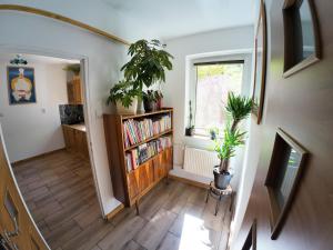 a hallway with a book shelf and a window at Stacja Srebrna Góra in Srebrna Góra