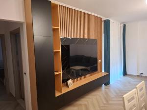 a living room with a flat screen tv on a wall at Patrisi Apartments in Sarandë