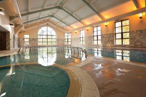 an indoor swimming pool with a swimming poolasteryasteryasteryasteryasteryasteryasteryastery at Westport Woods Hotel & Spa in Westport