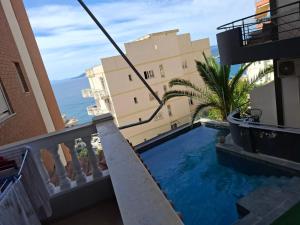 a view from a balcony of a building with a swimming pool at Patrisi Apartments in Sarandë