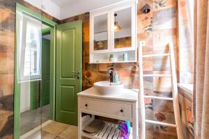 a bathroom with a sink and a green door at Apartments Lemon tree in Postira +61 photos