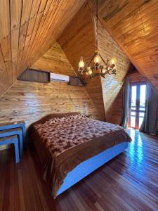 a large bed in a room with a wooden ceiling at Vila Gramado in Gramado +98 photos