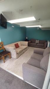 a living room with two couches and a couch at Hall Cottage, Wighill near York and Leeds in Tadcaster