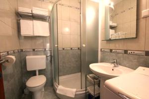a bathroom with a shower and a toilet and a sink at Apartments Artemis Dubrovnik in Dubrovnik +18 photos