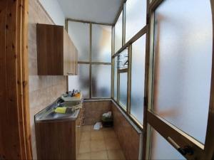 a small kitchen with a sink and a window at Casa vacanze Donna VALERIA in San Foca