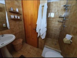 a bathroom with a shower and a toilet and a sink at Casa vacanze Donna VALERIA in San Foca