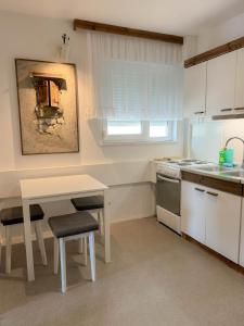 a kitchen with a table and a table and a sink at Apartment Romeo in Crikvenica