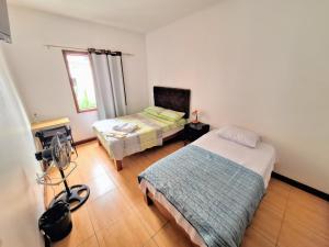 a room with two beds and a camera in it at Casa Villa Descanso in Lima