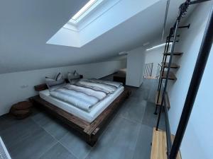a bedroom with a bed with a ladder in it at Ferienwohnung Sonnenschein in Oberlienz