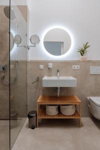 a bathroom with a sink and a mirror at Skyrise Apartments - Stilvoll wohnen, entspannt genießen in Bad Wörishofen