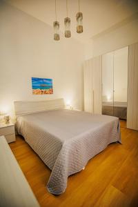 a bedroom with a large white bed in a room at Attracco Apartment in Trapani