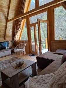 a room with a bed and a couch and a table at Holiday Home Veruša in Podgorica