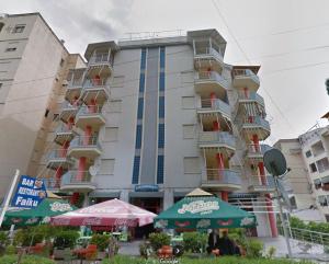 a tall building with umbrellas in front of it at Studio Apartment Golem in Golem