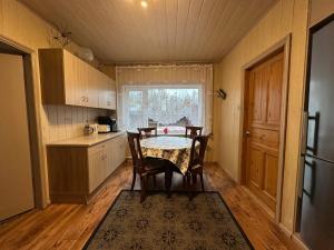 a kitchen with a table and chairs in a room at Kastan House in Mustvee