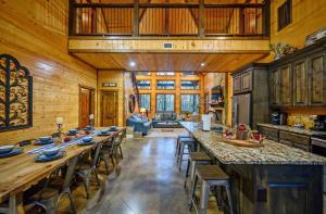 uma grande cozinha com uma mesa longa numa cabine em Lazy Daze Lodge - Hot Tub Playset & Firepit em Broken Bow