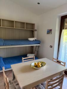 a room with a table with a bowl of fruit on it at Tenuta Magrè in Ischia Town