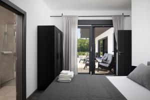 a bedroom with a bed and a sliding glass door at Vila Nora with heated pool in Marčana
