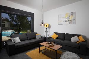 a living room with a couch and a table at Vila Nora with heated pool in Marčana