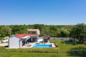 an aerial view of a house with a swimming pool at Vila Nora with heated pool in Marčana