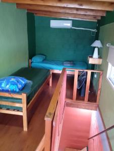 a room with two bunk beds and a table at Departamentos LUBRI 44 in Apóstoles