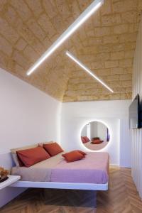 a bedroom with a bed and a mirror at Schinosa 30 luxury room in Bisceglie +43 photos