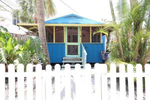 a blue house with a white fence at Siesta Key Island Rentals in Siesta Key +199 photos