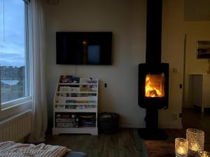 a living room with a wood burning stove in the corner at Casita de la Torre in Strömstad