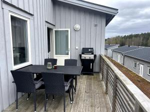 a patio with a table and chairs on a deck at Casita de la Torre in Strömstad
