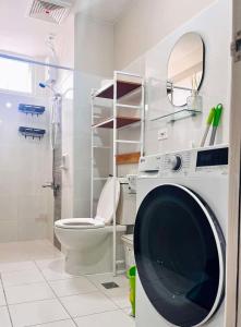 a washing machine in a bathroom with a toilet at Condo near Intramuros, Manila in Manila