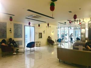 a lobby with people sitting in chairs in a building at Condo near Intramuros, Manila in Manila +7 photos