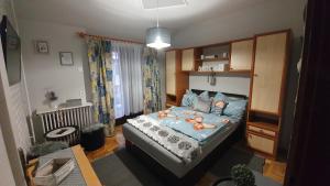 a bedroom with a bed with a blue comforter at Ágnes Vendégházak Siófok-apartman 3 in Siófok