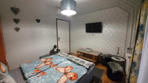 a bedroom with a bed with fish on it at Ágnes Vendégházak Siófok-apartman 3 in Siófok +7 photos