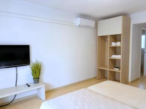 a white living room with a flat screen tv at Centric Rentalmar in Salou