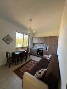 a living room with a couch and a table at Villa Mediterranea in Carini