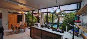 a kitchen with a large window and a dining room at Ballena Rey Hotel in Uvita