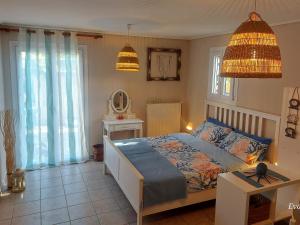 a bedroom with a bed and a table in it at Octopus Garden, Koralli Studio in Travliáta
