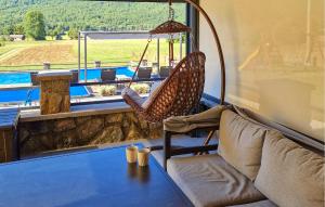 a living room with a couch and a window at Lovely Home In Gospic With Sauna in Gospić