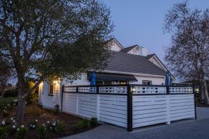 a white fence in front of a house at ONX WINES - Clark House Apartment in Templeton +8 photos