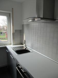 a white kitchen with a sink and a window at Kleine Wohlfühloase 2.0 in Heidelberg