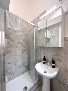 a bathroom with a sink and a shower at Benvenuto a Napoli in Naples