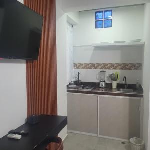 a kitchen with a sink and a counter top at Hostal Casa Marle in Puerto Colombia