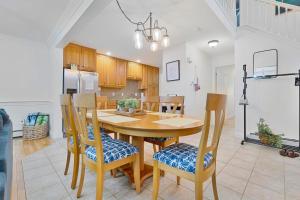 a kitchen and dining room with a wooden table and chairs at Golf & Coast Getaway 3br Tranquil Retreat in Old Orchard Beach