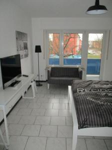 ein Wohnzimmer mit einem TV und einem Sofa in der Unterkunft Kleine Wohlfühloase 2.0 in Heidelberg + 4 Fotos