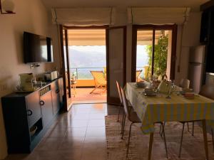 a kitchen and dining room with a table and a view at Piccola Mares Rapallo in Rapallo +34 photos