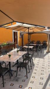 a group of tables and chairs with umbrellas at Hotel Boutique Del Buendia in San Luis Potosí