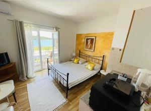 a small bedroom with a bed and a balcony at Apartments Esperanza in Pašman