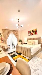 a large bedroom with a large bed and a table at The Essence Studios, Accra Kotoka Airport in Accra +55 photos